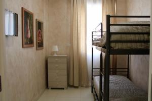 - une chambre avec 2 lits superposés et une commode dans l'établissement MEDUSA Residence B&B, à Margherita di Savoia