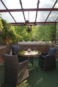 a patio with a table and chairs and a chandelier at "Am Griebnitzsee" 14482 Potsdam-Babelsberg in Potsdam