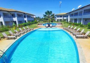 a large swimming pool with chairs and a resort at Tree Bies Resort in Entre Rios