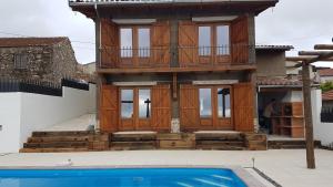 une maison avec une piscine en face de celle-ci dans l'établissement Casa da Cortiça, à Figueiró dos Vinhos