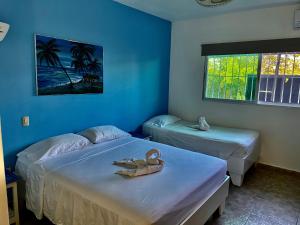 Postel nebo postele na pokoji v ubytování Albergo El Pulpo, Bayahíbe + 37 fotografií
