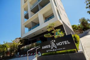 a hotel sign in front of a building at Ames Hotel & SPA in Vlorë