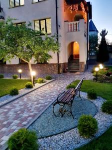 a park bench sitting in front of a building at Villa ZENKO in Lviv