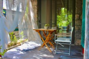 a table and a chair on a porch with a window at Valentina Boutique Hotel in Bozburun