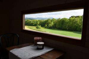 uma janela num quarto com uma mesa e vista em Leopold der Lamahütewagen em Oberndorf an der Melk