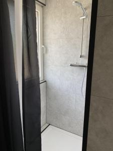 a shower with a glass door in a bathroom at Slapen bij van O 1 in Yerseke +23 photos