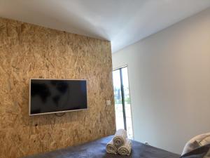 a room with a flat screen tv on a wall at Slapen bij van O 1 in Yerseke