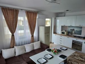 a living room with a couch and a table at Mona in Mamaia