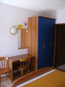 a room with a desk and a blue cabinet at Room in Vodice with balcony, air conditioning, Wi-Fi (4826-3) in Vodice