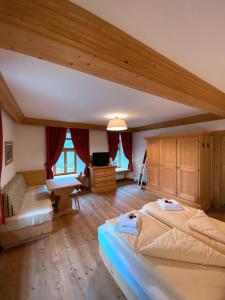 a large bedroom with two beds in a room at Ristorante Rifugio Ospitale in Cortina dʼAmpezzo