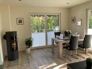 a dining room with a table and chairs and a window at Ferienhaus Hanna in Waren