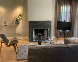 a living room with a couch and a fireplace at Hoeve Altena Apartment in Woudrichem