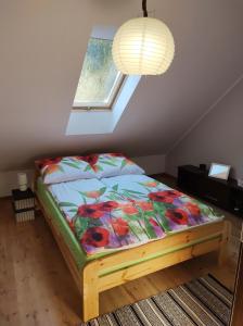 een bed in een kamer met een raam bij Dom na skraju lasu in Serwy