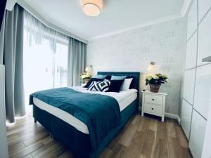 Ένα ή περισσότερα κρεβάτια σε δωμάτιο στο SeaHome Horyzont z parkingiem