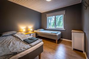 a bedroom with two beds and a window at Jõeranna Lodge in Paope