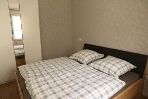 a bed with two pillows on it in a room at Ferienwohnung Evi in Walkenried