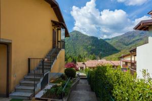 a stairway leading up to a building with mountains in the background at La Cà Dol Sùl in Orezzo