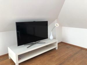 Televízia a/alebo spoločenská miestnosť v ubytovaní SUN HOUSE