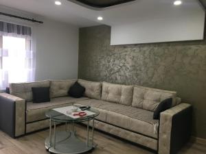 a living room with a couch and a table at Zlatarska čarolija in Nova Varoš