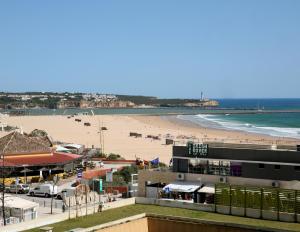 a view of a beach with a building and a beach at Varandas SEA VIEW - Praia da Rocha in Portimão