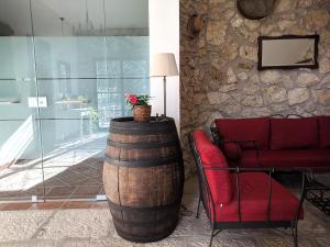 a room with a wine barrel and a red chair at Casale Ginisara in Castellammare del Golfo