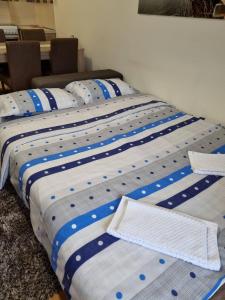 a group of three beds sitting next to each other at Aphrodite Apartment in Podgorica