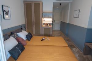 A bed or beds in a room at Mageiras Boutique Hotel