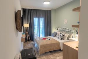 A bed or beds in a room at Mageiras Boutique Hotel