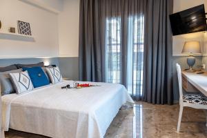 A bed or beds in a room at Mageiras Boutique Hotel
