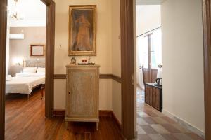 a hallway with a mirror and a room with a bed at Beautiful City Suites in Athens