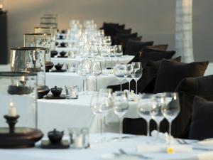 a row of tables with wine glasses on them at 5-Star Boutique Hotel The Lombok Lodge in Tanjung