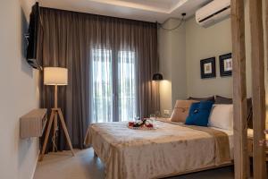 A bed or beds in a room at Mageiras Boutique Hotel