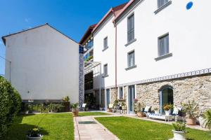 a large white building with a yard at Ispani Inn Resort in Ispani