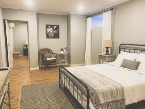 a bedroom with a bed and a chair and a window at Quinta Costa da Estrela in Gouveia
