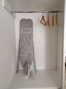 a closet with a chair and hangers at Нова 2х кімнатна в центре in Rivne