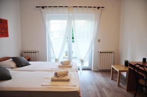 Postel nebo postele na pokoji v ubytování Apartmani Alavuk