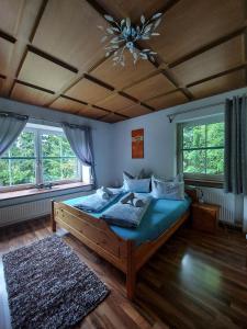 a bedroom with a large wooden bed with a chandelier at Haus Emily in Schladming