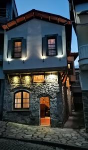 an old stone house with a door in front at RiverBed Traditional Guest House in Litochoro
