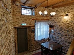 a dining room with a table and a window at RiverBed Traditional Guest House in Litochoro