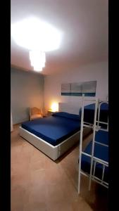 a bedroom with a bed with two bunk beds at A casa dell’amica mia in San Nicola Arcella