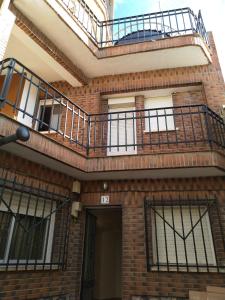 a brick building with balconies on top of it at Casa Rural El Rincon del descanso in Yebra