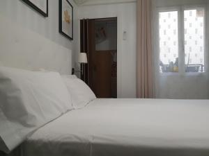 Łóżko lub łóżka w pokoju w obiekcie Apartment Tirso Molina
