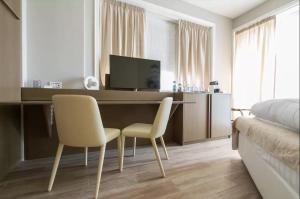 TV a/nebo společenská místnost v ubytování Ginevra Rooms