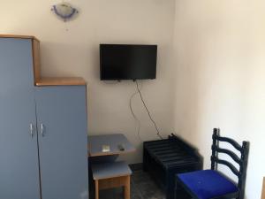 a room with a tv hanging on the wall at Casa Poseidon in Costinesti