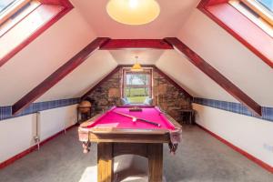 a room with a pool table in a attic at Meadowhead Cottage, Traditional Scottish Cottage in Waterside +7 photos