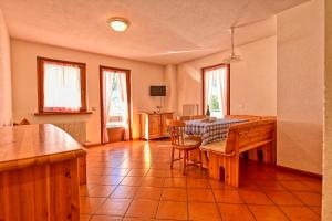a kitchen with a table and chairs in a room at Casa Pienzi in Valdidentro