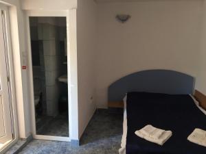 a bedroom with a bed with two towels on it at Casa Poseidon in Costinesti +8 photos