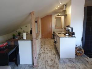 a kitchen with white cabinets and a counter top at KK Apartment city in Ventspils