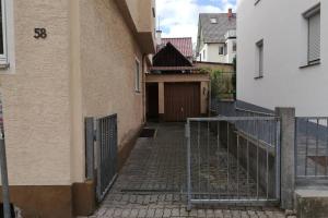 an alley between two buildings with a gate at Vacation Apartment In The Black Forest in Villingen-Schwenningen