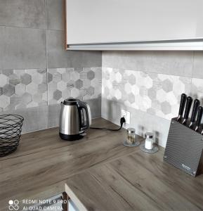 a kitchen counter top with a coffee pot on it at VIEW 20 APARTAMENT in Giżycko